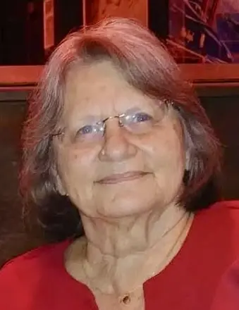 Elderly woman with glasses wearing red top