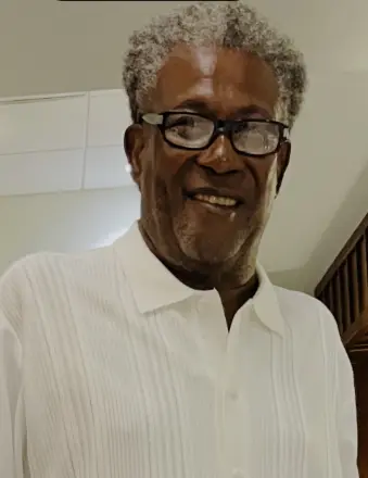 Smiling older man wearing glasses and white shirt