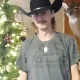 Man in cowboy hat by Christmas tree