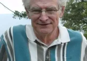 Older man with white hair wearing striped shirt