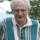 Older man with white hair wearing striped shirt