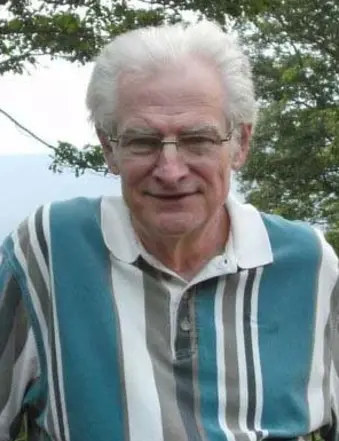 Older man with white hair wearing striped shirt