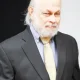 Older man in suit with gray beard