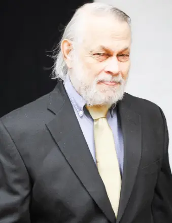 Older man in suit with gray beard