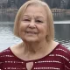 Elderly woman smiling by lakeside