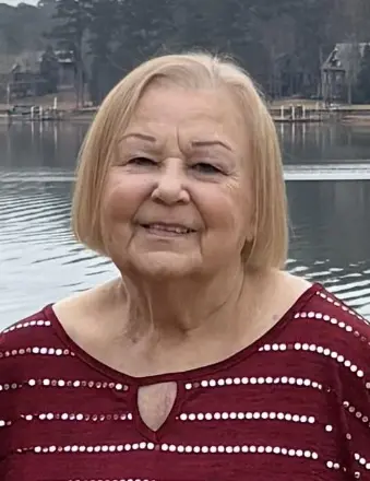 Elderly woman smiling by lakeside