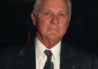 Older man in dark suit and tie