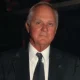 Older man in dark suit and tie