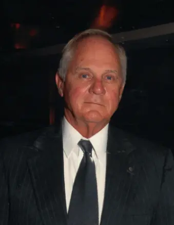 Older man in dark suit and tie