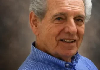 Smiling older man in blue shirt portrait