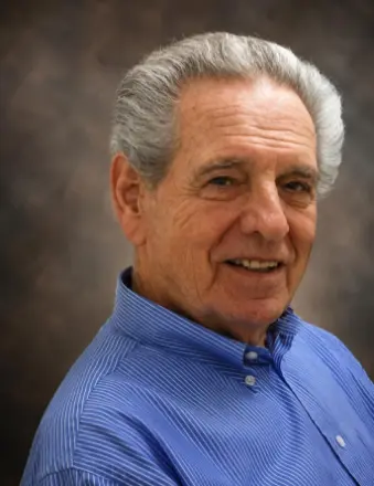 Smiling older man in blue shirt portrait