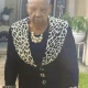 Elderly woman in black outfit with leopard print