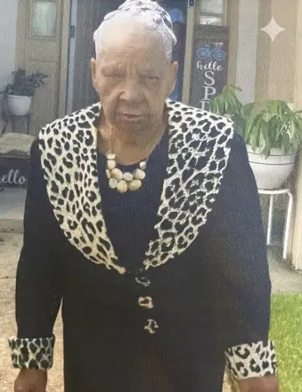 Elderly woman in black outfit with leopard print