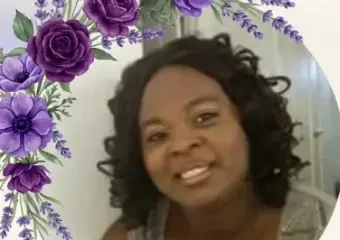 Smiling woman framed by purple floral border