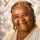 Smiling woman in white with doves and clouds background