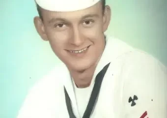 Young sailor in white Navy uniform portrait