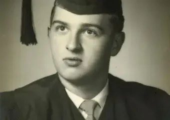 Black-and-white portrait of male graduate in cap