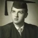 Black-and-white portrait of male graduate in cap