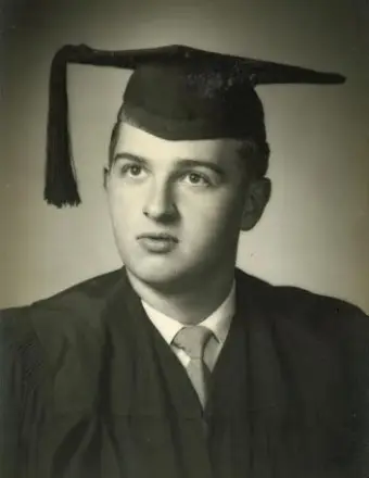Black-and-white portrait of male graduate in cap