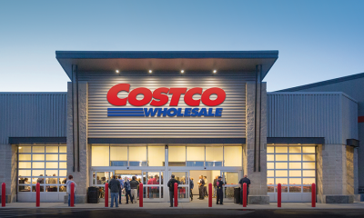 Costco Wholesale storefront at dusk with shoppers