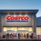 Costco Wholesale storefront at dusk with shoppers