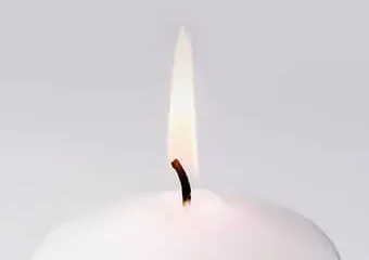 Close-up of lit white candle flame