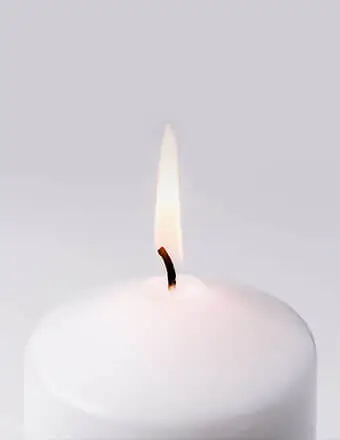 Close-up of lit white candle flame