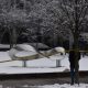 Snow-covered sculpture cordoned with caution tape outdoors