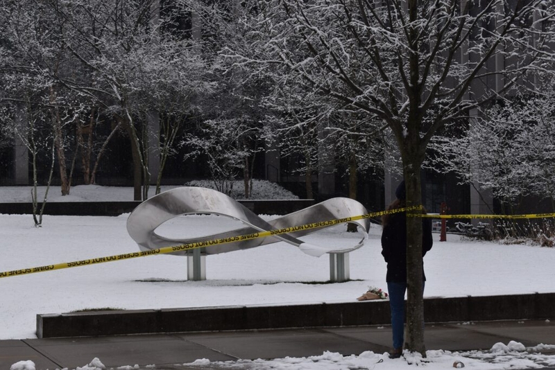 Snow-covered sculpture cordoned with caution tape outdoors