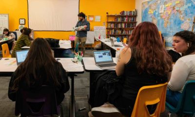 Teacher holding baby doll in classroom discussion