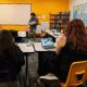 Teacher holding baby doll in classroom discussion