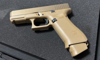 Tan Glock 19X pistol on black surface
