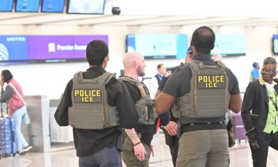 ICE police officers standing in airport terminal