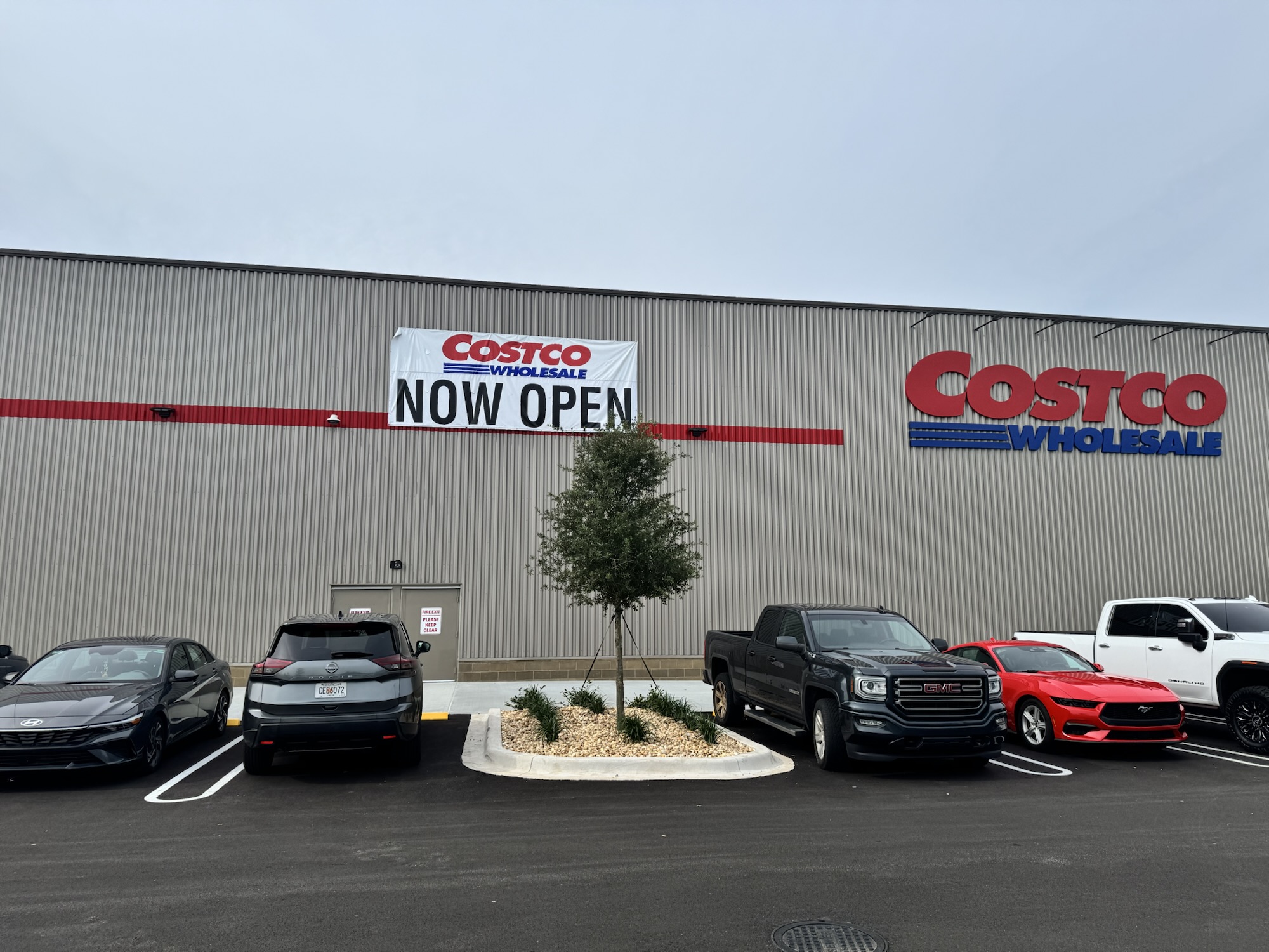 Costco Wholesale storefront with Now Open banner