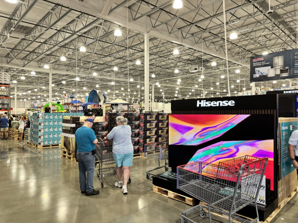 Costco electronics section with large Hisense TV display