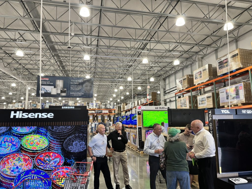 Customers browsing large TVs in Grand opening of Costco  warehouse