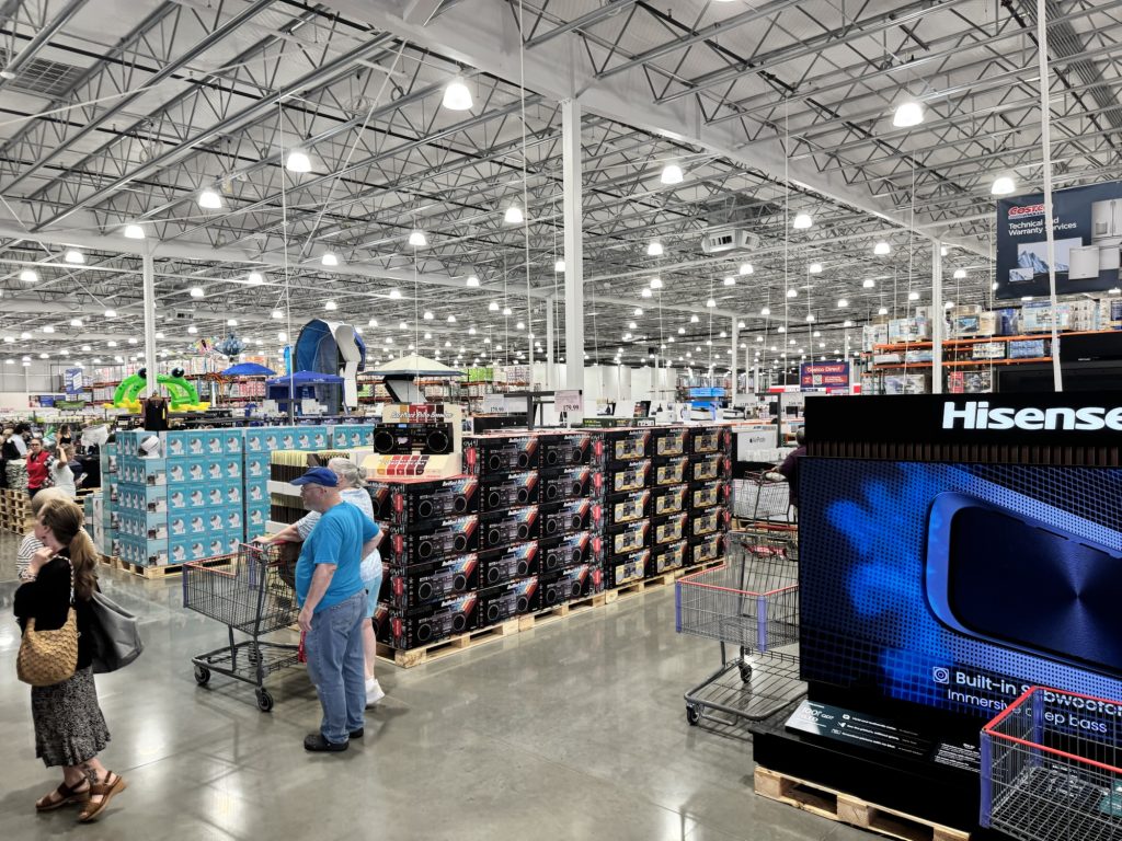 Shoppers inside Grand opening of Costco  warehouse  store with electronics displays