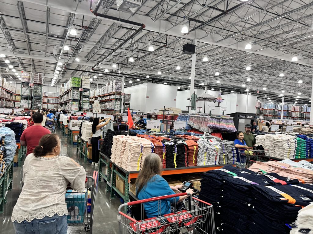 Grand opening of Costco  warehouse store clothing section with shoppers and carts