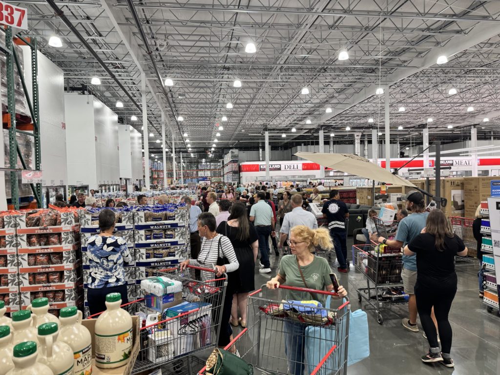 Crowded Costco warehouse with shoppers and carts