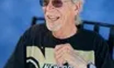 Smiling man wearing New Orleans Saints shirt