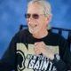 Smiling man wearing New Orleans Saints shirt