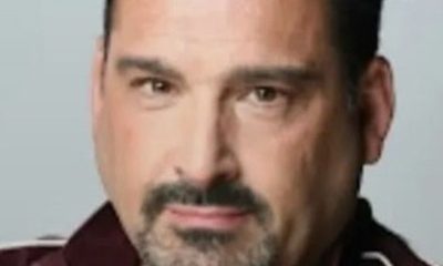 Headshot of man with goatee in maroon jacket