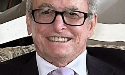 Smiling elderly man in suit and glasses