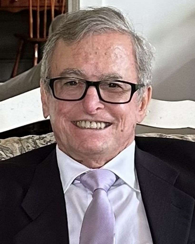 Smiling elderly man in suit and glasses