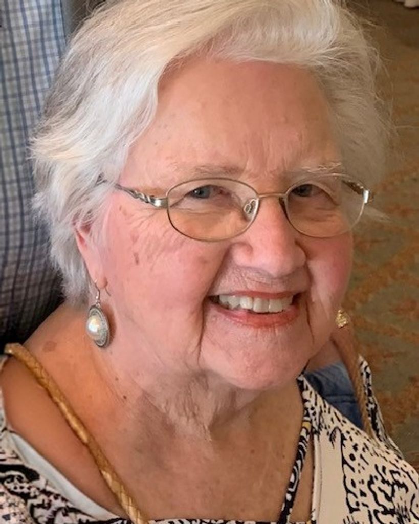 Smiling elderly woman wearing glasses and earrings