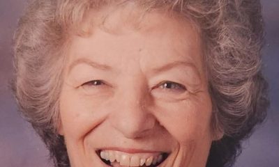 Smiling elderly woman with gray curly hair