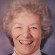 Smiling elderly woman with gray curly hair