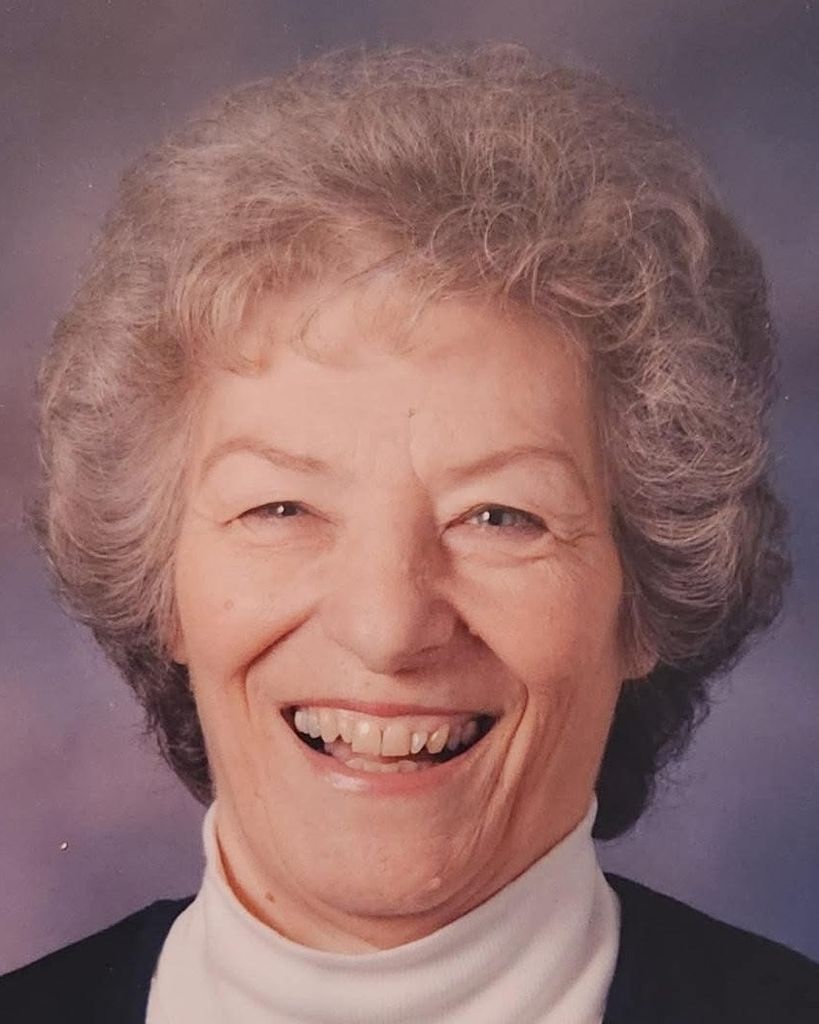 Smiling elderly woman with gray curly hair