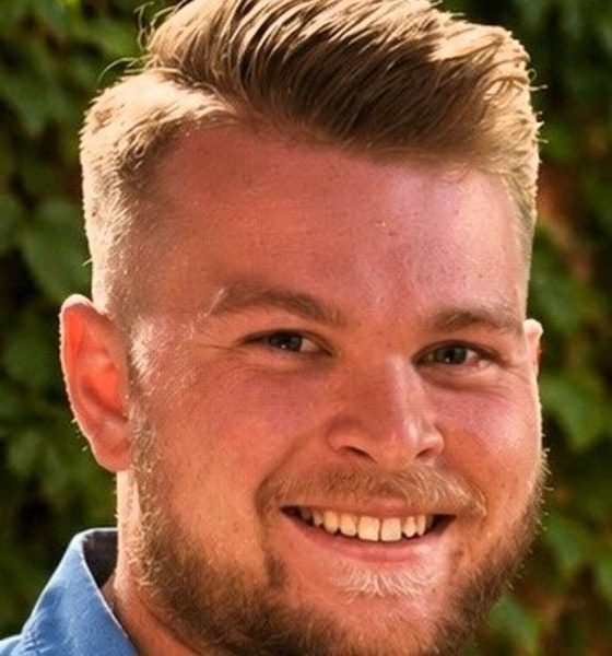 Smiling young man with blond hair outdoors