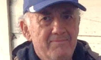 Elderly man wearing blue baseball cap outdoors